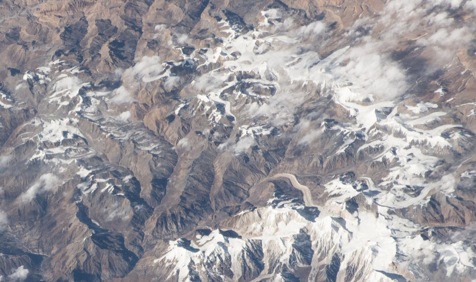 A satellite view from the International Space Station showing the snow-covered Himlung Himal and surrounding glaciated peaks in Nepal's Manang district.