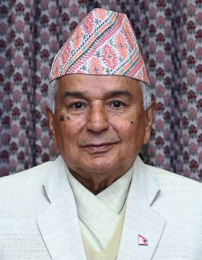 Official portrait of Nepal's President Ram Chandra Poudel, wearing a traditional Dhaka topi, posed against a floral backdrop.
