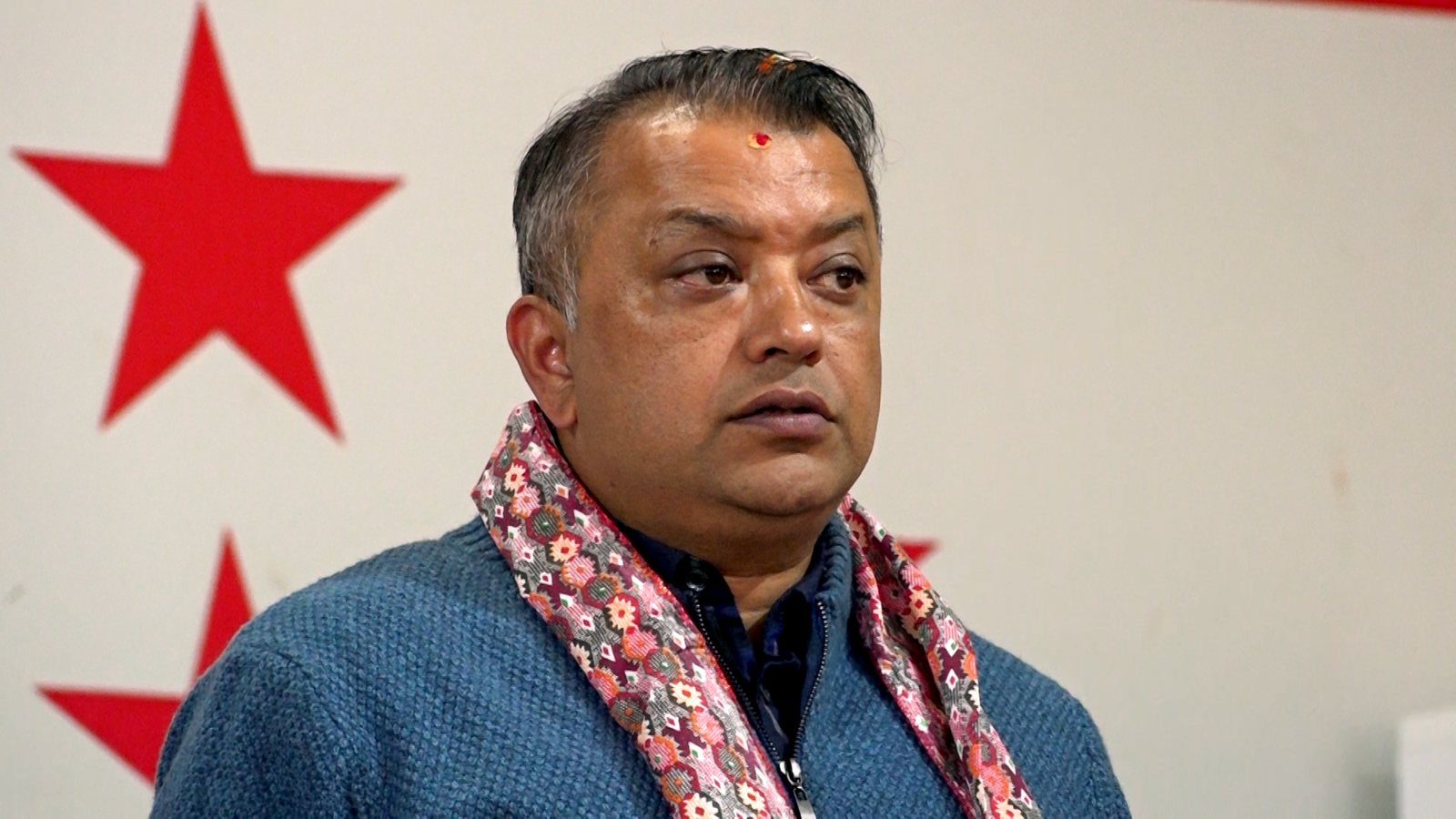 A portrait photograph of Nepali politician Gagan Kumar Thapa, dressed in formal attire, looking toward the camera.