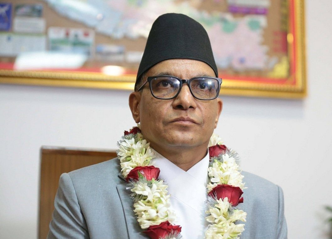 Chief Justice Manoj Kumar Sharma, wearing a grey suit and garlanded with flowers, pictured at his swearing-in ceremony.